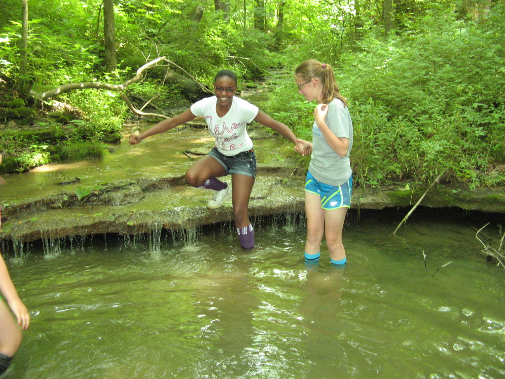 Local youth explore the waterfall area on the southeast side of the property
